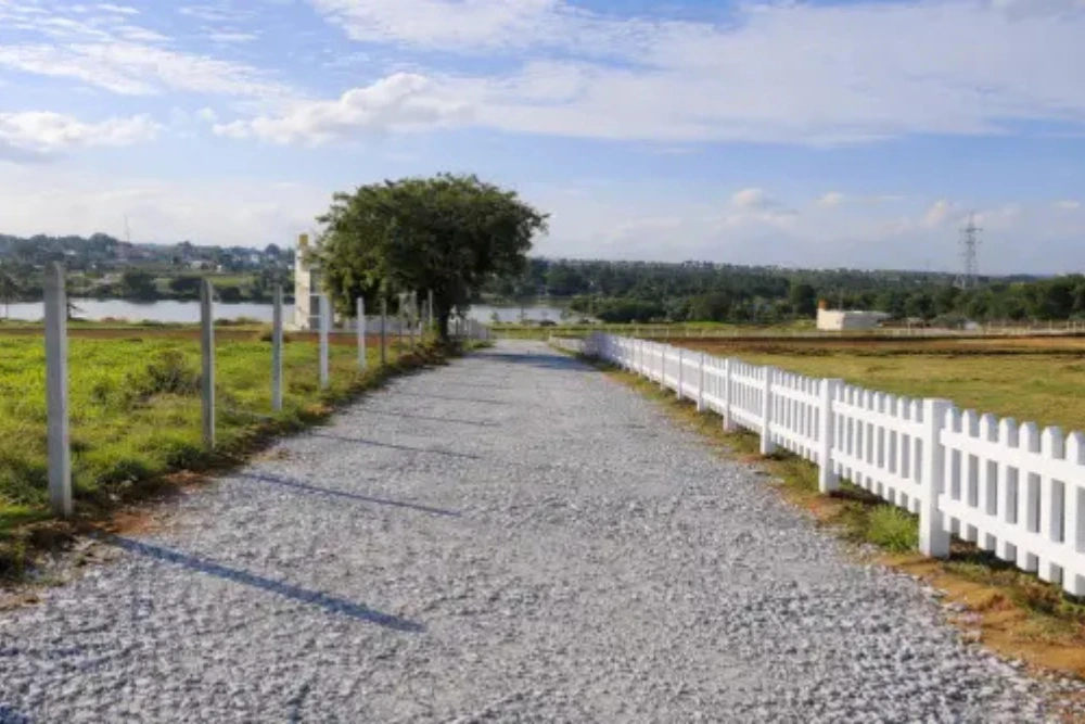 Lakeview project internal roads in denkanikottai with picket fencing and greenery.