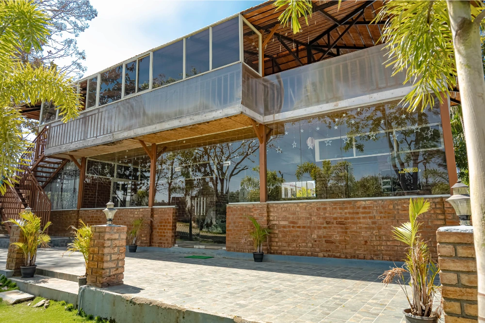 Vasudha kalpataru guest house building with modern design and serene surroundings.